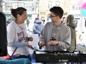 two members of the Community resource team enjoying themselves and laughing while at the volunteers in the square team