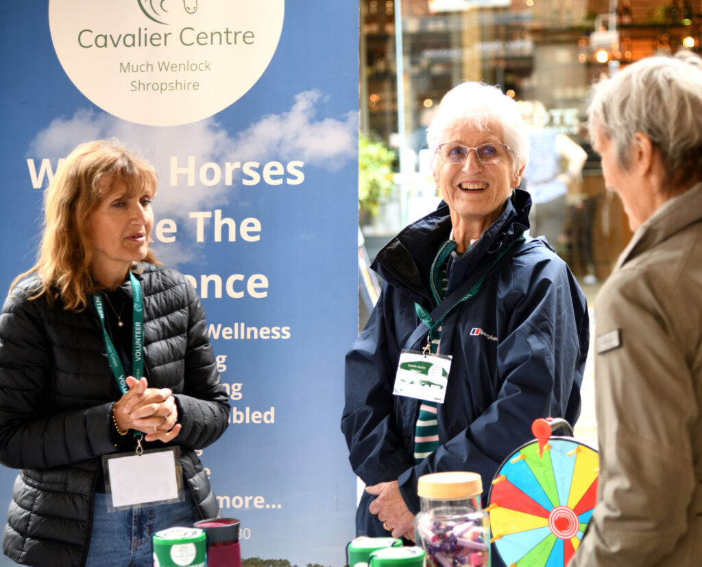 a member of the public engaging with the cavalier centre team at the volunteers in the square event