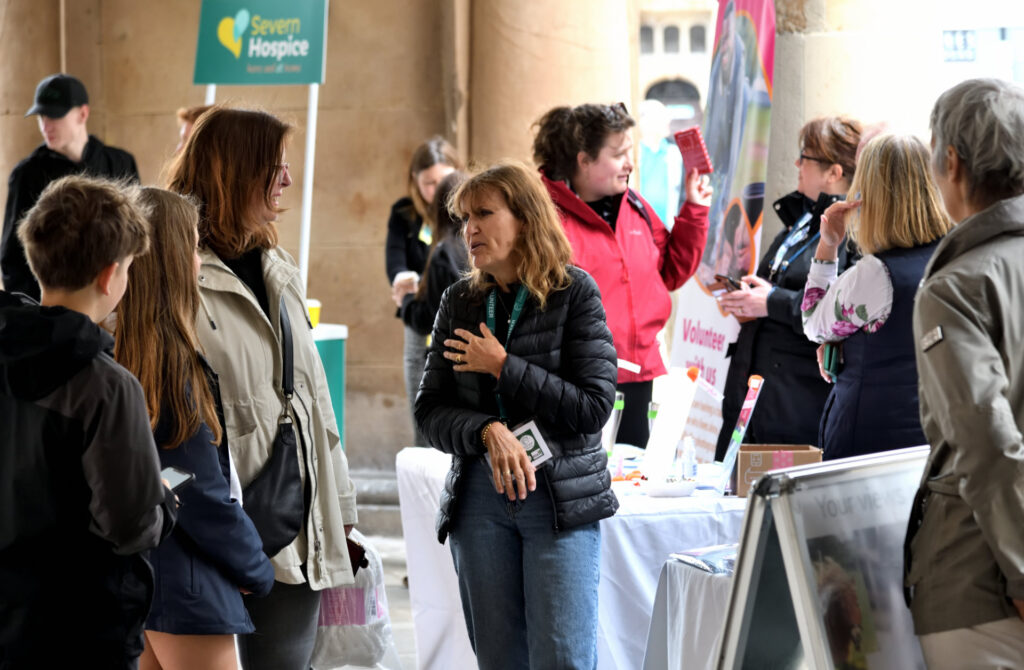 members of the public engaging with stalls at the volunteers in the square event