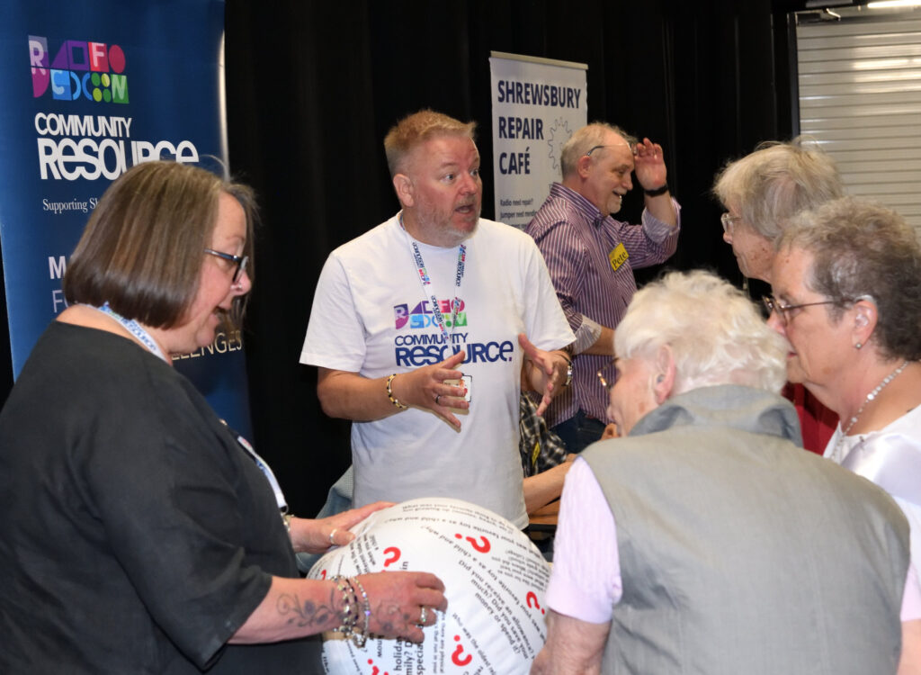 Attendees at the see, hear, remember exhibition engaging with the Community Resource team.