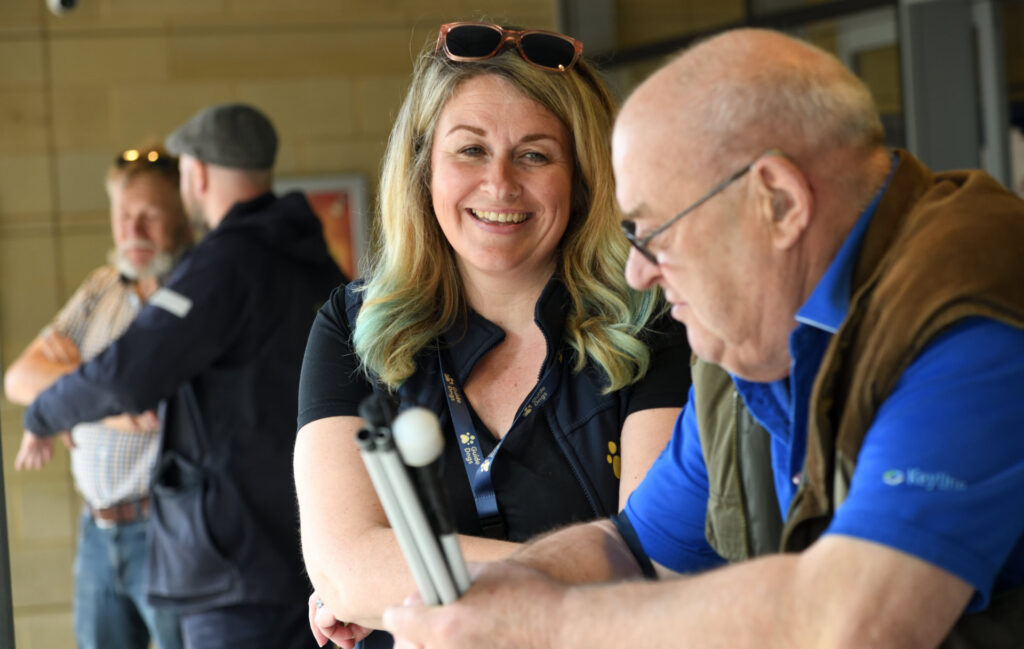 Attendees at the see, hear, remember exhibition engaging with exhibitors.